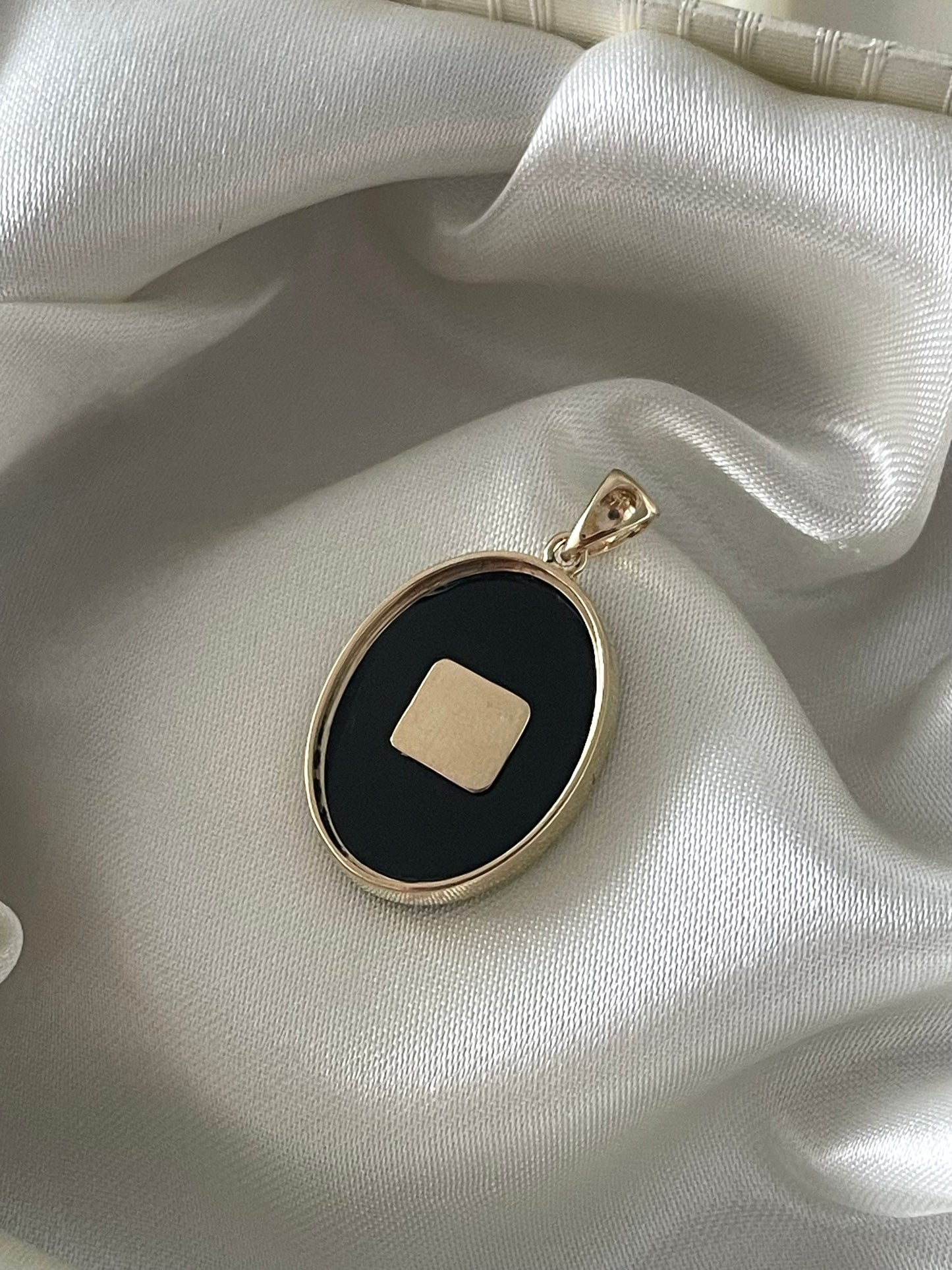 Art deco style 9ct yellow gold onyx pendant with natural emerald