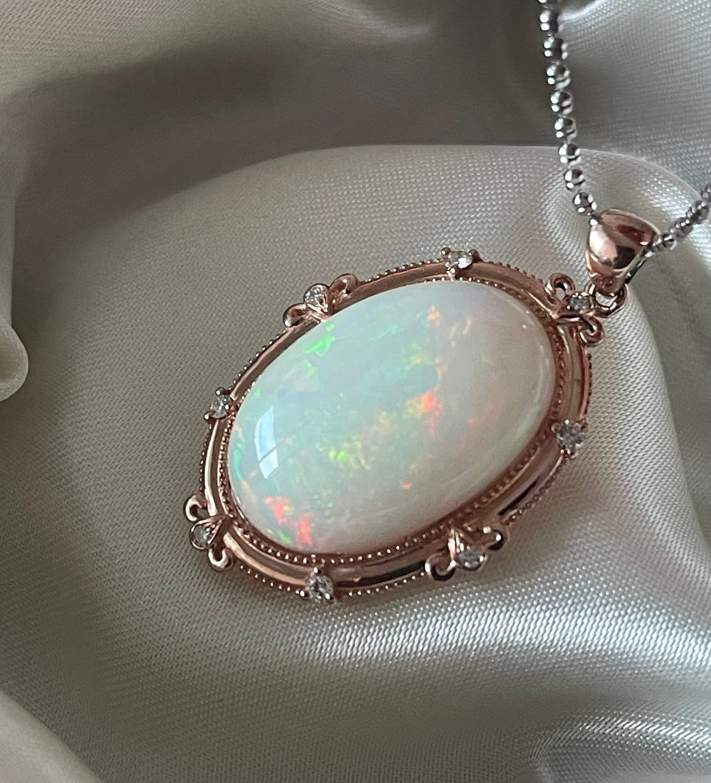 Bespoke 9ct rose gold 16ct natural opal pendant with diamonds