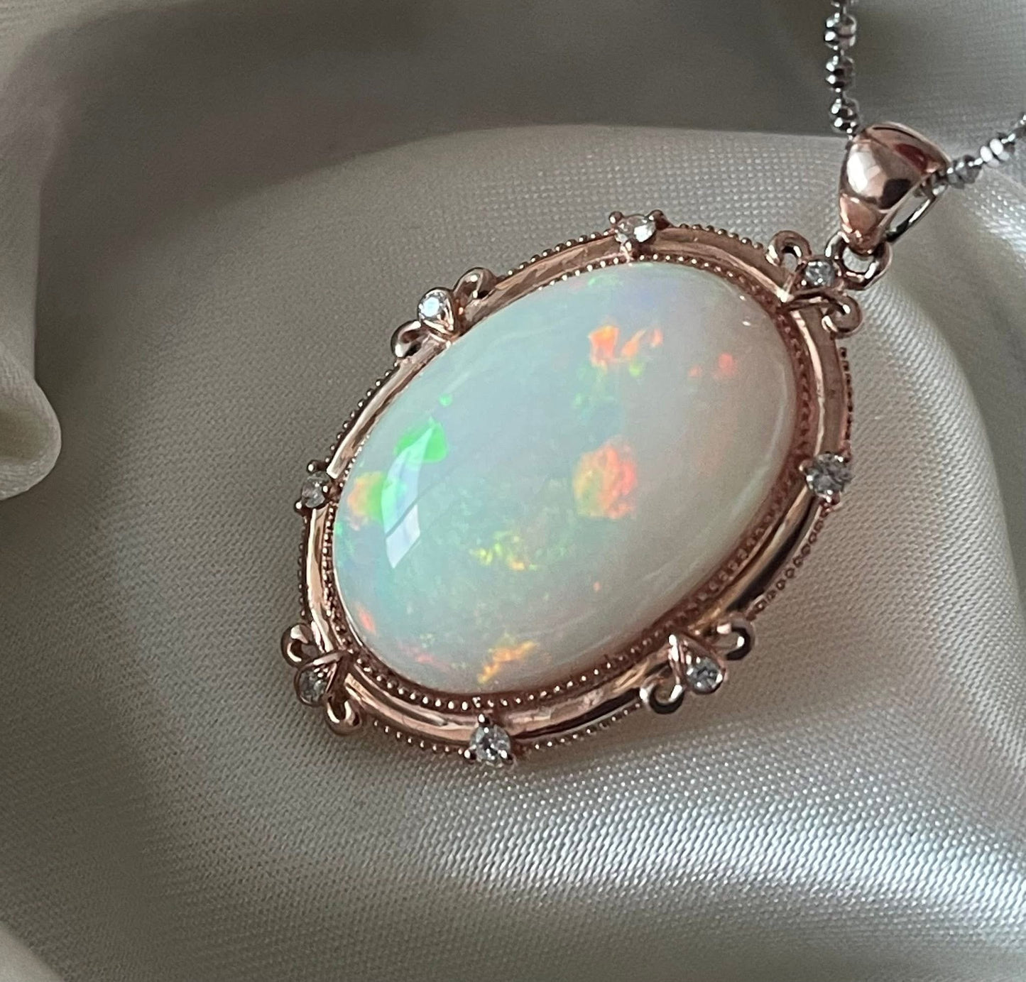 Bespoke 9ct rose gold 16ct natural opal pendant with diamonds
